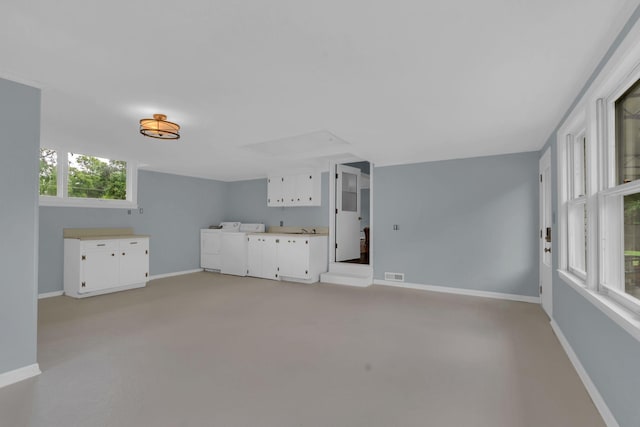 1118 Houston Dr, Murfreesboro, TN 37130 - unfurnished living room with washing machine and dryer and light carpet