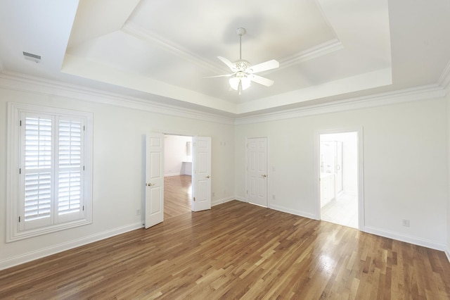 1176 Fairvue Village Ln, Gallatin, TN 37066 - unfurnished room featuring a tray ceiling, ceiling fan, wood finished floors, and crown molding