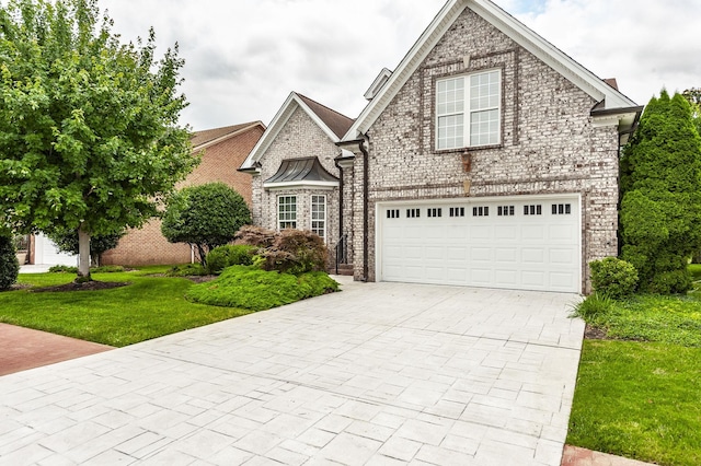 1176 Fairvue Village Ln, Gallatin, TN 37066 - view of front facade with decorative driveway, a front yard, and brick siding