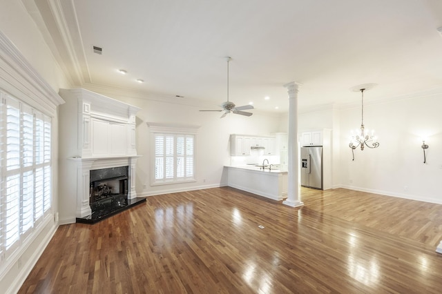 1176 Fairvue Village Ln, Gallatin, TN 37066 - unfurnished living room featuring ceiling fan, ornamental molding, wood finished floors, a high end fireplace, and ornate columns