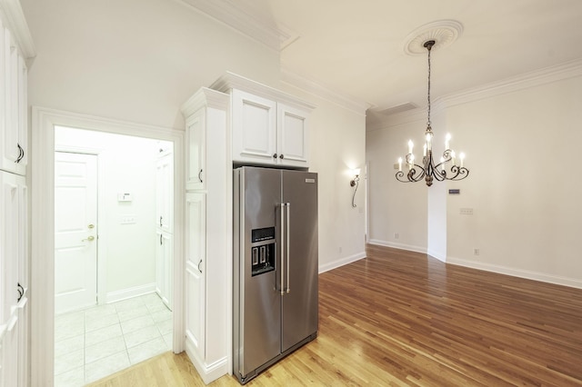 1176 Fairvue Village Ln, Gallatin, TN 37066 - kitchen featuring high end fridge, a chandelier, ornamental molding, light wood-type flooring, and white cabinets