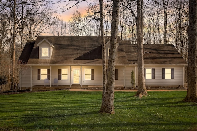 1064 Crane Ct, Kingston Springs, TN 37082 - cape cod-style house featuring a porch, a lawn, and a shingled roof