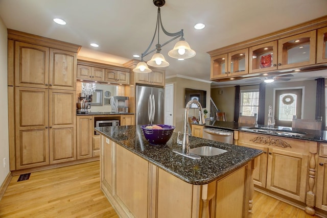 1064 Crane Ct, Kingston Springs, TN 37082 - kitchen featuring appliances with stainless steel finishes, ornamental molding, glass insert cabinets, light wood finished floors, and dark stone countertops
