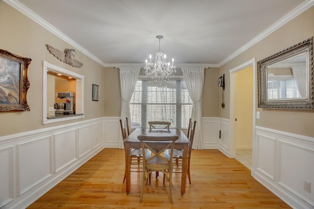 1064 Crane Ct, Kingston Springs, TN 37082 - dining space with a chandelier, light wood-type flooring, ornamental molding, a decorative wall, and wainscoting