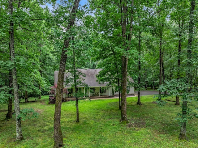 1064 Crane Ct, Kingston Springs, TN 37082 - view of front of home featuring a front lawn, covered porch, and a view of trees