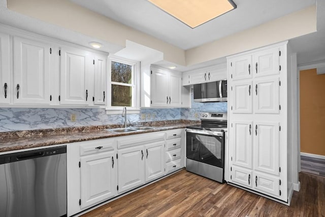 120 Dove Ln, Monroe, TN 38573 - kitchen featuring stainless steel appliances, dark countertops, backsplash, white cabinets, and dark wood-type flooring