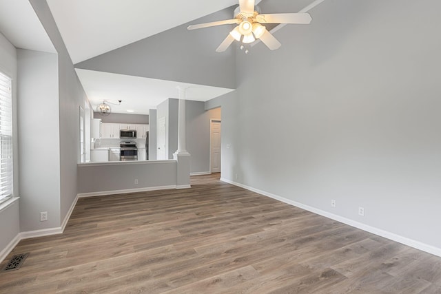 1220 Kelly Ct, Franklin, TN 37064 - unfurnished living room with high vaulted ceiling, plenty of natural light, ceiling fan, and wood finished floors