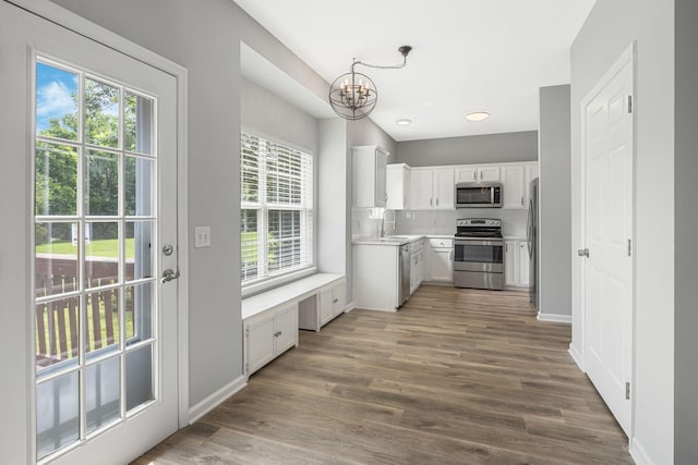1220 Kelly Ct, Franklin, TN 37064 - kitchen with appliances with stainless steel finishes, a chandelier, healthy amount of natural light, and wood finished floors