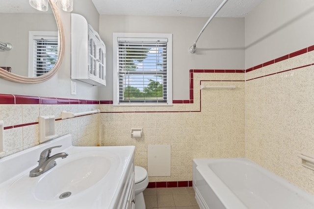 2709 Emery Dr, Nashville, TN 37214 - bathroom featuring tile patterned floors, tile walls, vanity, wainscoting, and bathtub / shower combination
