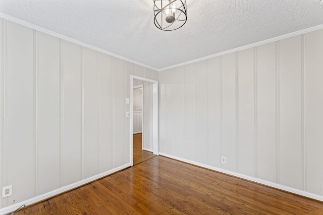 2709 Emery Dr, Nashville, TN 37214 - unfurnished room featuring wood finished floors, a decorative wall, ornamental molding, and a textured ceiling