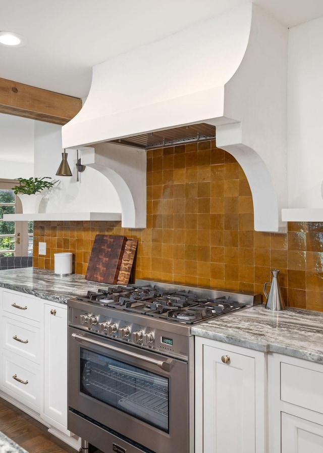 1231 Carl Seyfert Memorial Dr, Brentwood, TN 37027 - kitchen featuring stainless steel stove, custom exhaust hood, white cabinetry, light stone counters, and backsplash