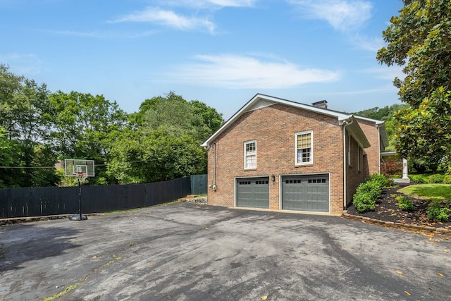 1231 Carl Seyfert Memorial Dr, Brentwood, TN 37027 - view of side of property featuring driveway, a garage, brick siding, and a chimney
