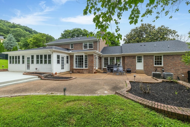 1231 Carl Seyfert Memorial Dr, Brentwood, TN 37027 - back of property with entry steps, a patio area, brick siding, and a lawn