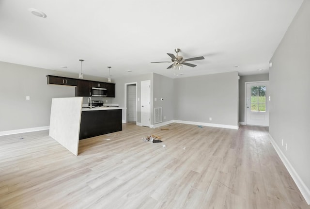 2670 Scott Dr, Clarksville, TN 37042 - unfurnished living room featuring a ceiling fan and light wood-type flooring