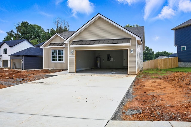 2670 Scott Dr, Clarksville, TN 37042 - view of front facade featuring board and batten siding, an attached garage, concrete driveway, a standing seam roof, and a metal roof