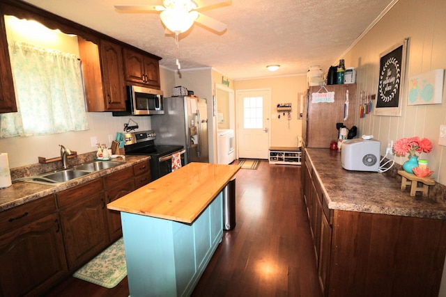 60 Jayson St, Camden, TN 38320 - kitchen featuring stainless steel appliances, washer / dryer, crown molding, dark wood-style flooring, and wooden counters