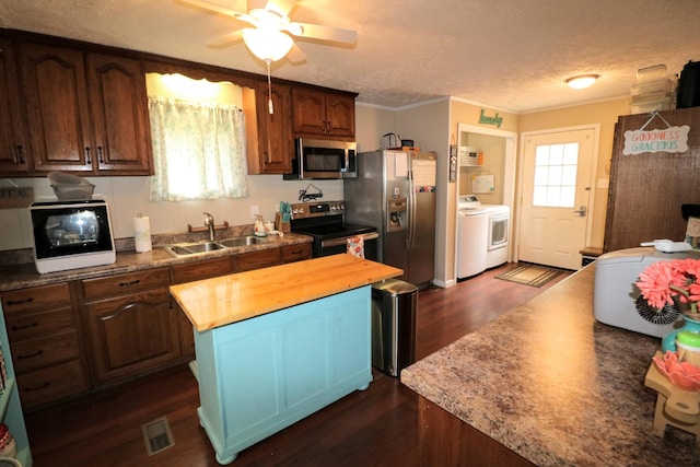 60 Jayson St, Camden, TN 38320 - kitchen with appliances with stainless steel finishes, butcher block counters, separate washer and dryer, dark wood-style floors, and a ceiling fan
