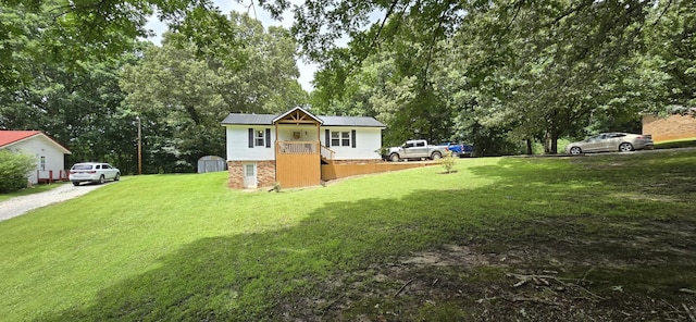 60 Jayson St, Camden, TN 38320 - view of grassy yard with a storage unit and view of scattered trees