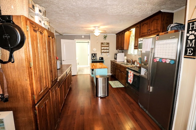 60 Jayson St, Camden, TN 38320 - kitchen with stainless steel appliances, a textured ceiling, dark wood-style floors, a ceiling fan, and ornamental molding