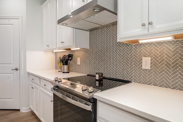 468 Rosy Dale Dr, Gallatin, TN 37066 - kitchen featuring stainless steel range with electric cooktop, ventilation hood, decorative backsplash, and white cabinetry