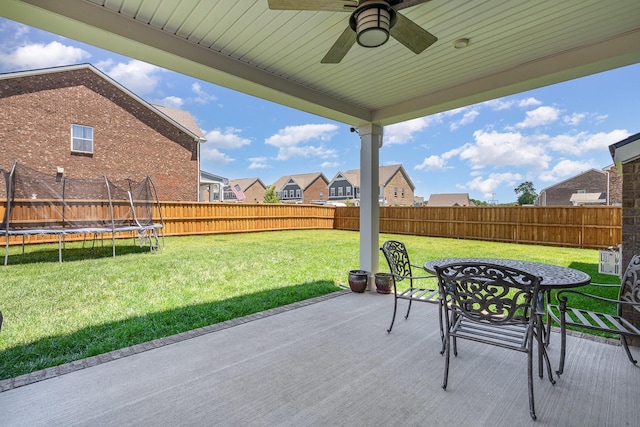 468 Rosy Dale Dr, Gallatin, TN 37066 - fenced backyard featuring a trampoline, a ceiling fan, a patio, outdoor dining area, and a residential view