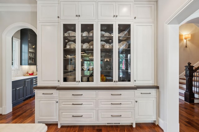 114 Middleton Cir, Nashville, TN 37215 - bar area with arched walkways, dark wood-style flooring, stairway, and backsplash
