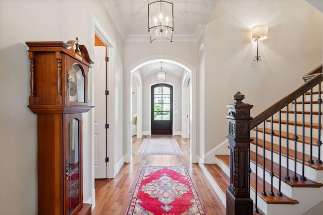 114 Middleton Cir, Nashville, TN 37215 - foyer entrance with arched walkways, a chandelier, wood finished floors, stairs, and crown molding