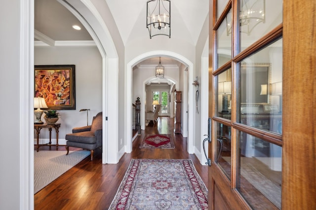 114 Middleton Cir, Nashville, TN 37215 - foyer entrance with arched walkways, a chandelier, dark wood-style flooring, and crown molding