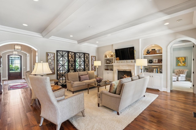 114 Middleton Cir, Nashville, TN 37215 - living room featuring arched walkways, crown molding, wood finished floors, beamed ceiling, and a warm lit fireplace