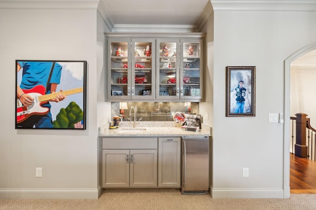 114 Middleton Cir, Nashville, TN 37215 - indoor wet bar featuring ornamental molding, stainless steel fridge, light colored carpet, and arched walkways