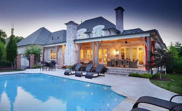 114 Middleton Cir, Nashville, TN 37215 - rear view of property featuring a patio area, outdoor dining area, a chimney, and brick siding