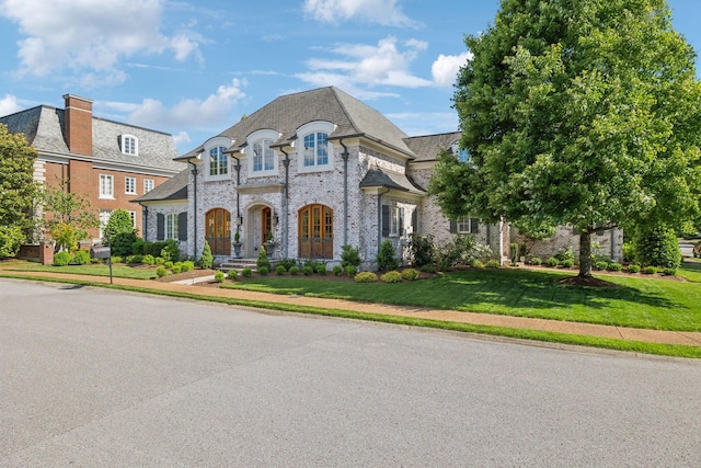 114 Middleton Cir, Nashville, TN 37215 - french country inspired facade featuring a front yard, brick siding, and a high end roof