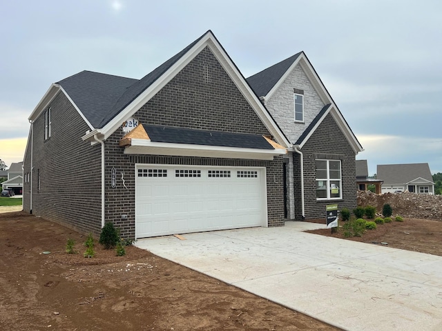 1720 Merkel Rd, Columbia, TN 38401 - view of front of house with an attached garage, brick siding, and driveway