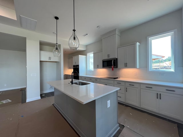 1720 Merkel Rd, Columbia, TN 38401 - kitchen with black appliances, tasteful backsplash, a kitchen island with sink, hanging light fixtures, and white cabinetry