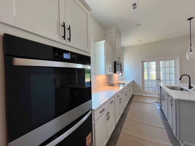 1720 Merkel Rd, Columbia, TN 38401 - kitchen with stainless steel appliances, light countertops, decorative backsplash, and white cabinetry