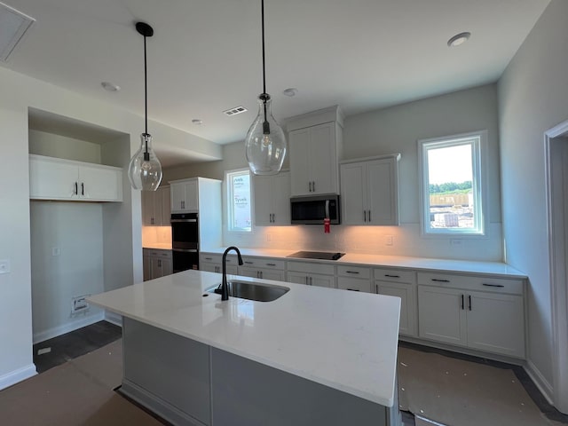 1720 Merkel Rd, Columbia, TN 38401 - kitchen with black appliances, backsplash, a kitchen island with sink, and white cabinetry