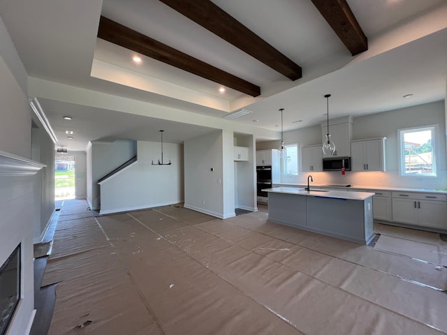 1720 Merkel Rd, Columbia, TN 38401 - kitchen with stainless steel appliances, open floor plan, a center island with sink, beam ceiling, and light countertops
