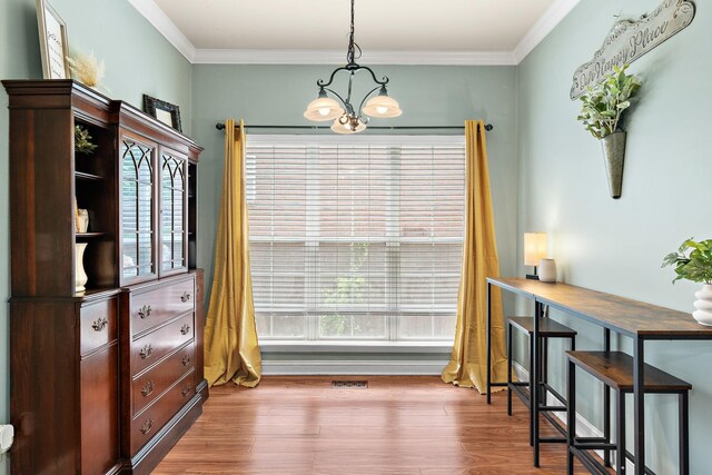 604 Applejack Ct, Antioch, TN 37013 - dining room featuring a chandelier, wood finished floors, and ornamental molding