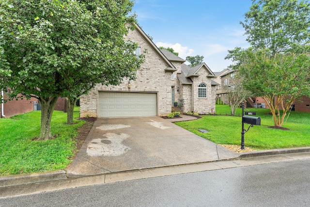 604 Applejack Ct, Antioch, TN 37013 - view of front of house with brick siding, driveway, a front lawn, and an attached garage