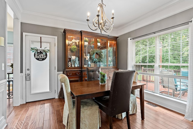 604 Applejack Ct, Antioch, TN 37013 - dining area with a chandelier, crown molding, and light wood-type flooring