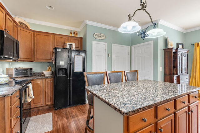 604 Applejack Ct, Antioch, TN 37013 - kitchen featuring black appliances, dark wood-style flooring, crown molding, brown cabinetry, and a center island