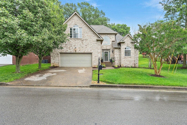 604 Applejack Ct, Antioch, TN 37013 - french country home featuring driveway, an attached garage, a front yard, brick siding, and roof with shingles