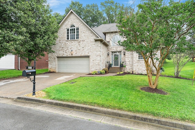604 Applejack Ct, Antioch, TN 37013 - view of front of home featuring a garage, driveway, a front yard, and brick siding