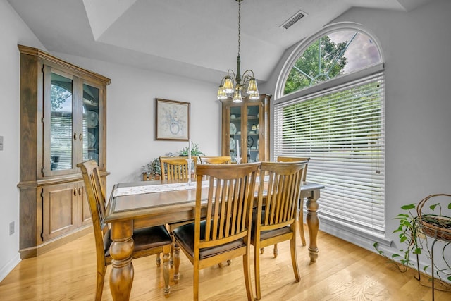1013 Laurel Hills Dr, Dickson, TN 37055 - dining room with a chandelier, lofted ceiling, healthy amount of natural light, and light wood-style flooring