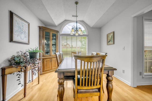 1013 Laurel Hills Dr, Dickson, TN 37055 - dining space featuring a chandelier, lofted ceiling, light wood-style floors, and a textured ceiling