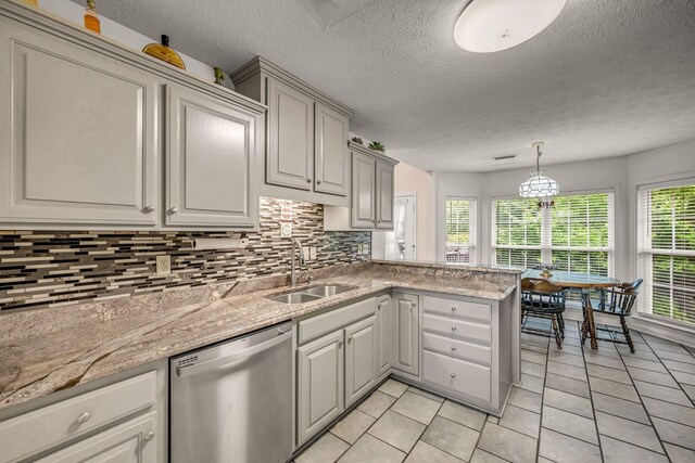 1013 Laurel Hills Dr, Dickson, TN 37055 - kitchen featuring dishwasher, tasteful backsplash, light tile patterned floors, a peninsula, and a textured ceiling
