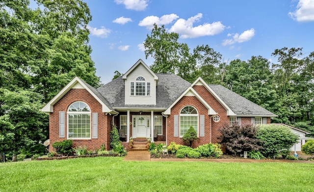 1013 Laurel Hills Dr, Dickson, TN 37055 - traditional home featuring brick siding, a front yard, and a shingled roof