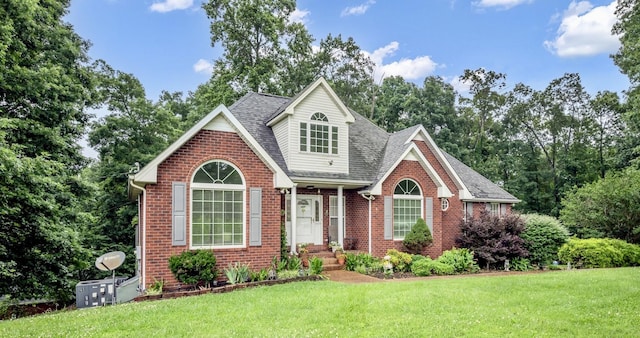 1013 Laurel Hills Dr, Dickson, TN 37055 - traditional home with brick siding, a shingled roof, a front yard, and view of wooded area