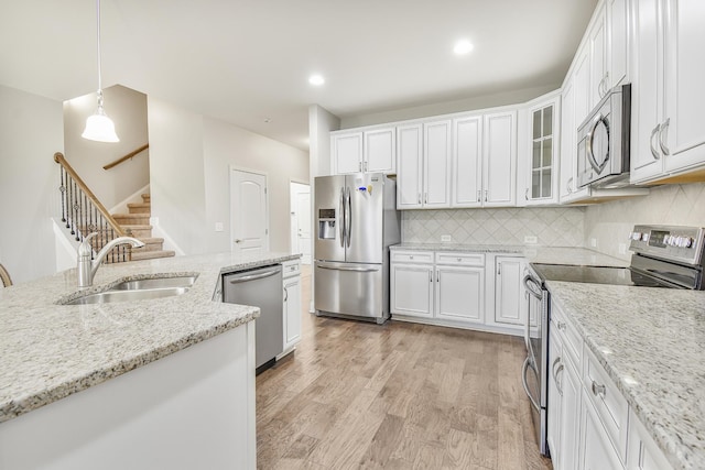 835 Meadowcrest Way, Lebanon, TN 37090 - kitchen with stainless steel appliances, white cabinets, light wood finished floors, backsplash, and recessed lighting