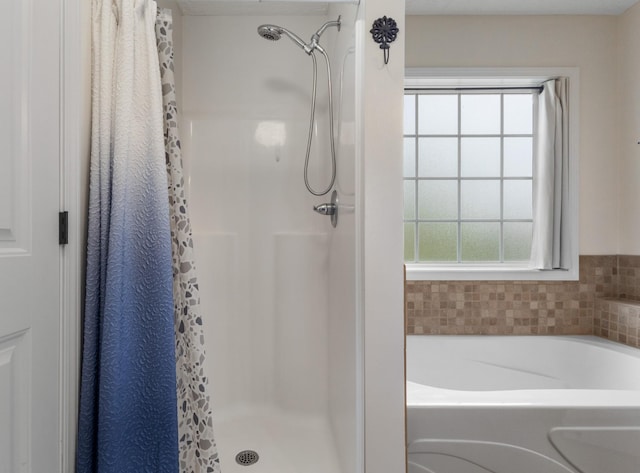 989 Ernest Stewart Dr, Clarksville, TN 37042 - bathroom with healthy amount of natural light, a stall shower, and a garden tub